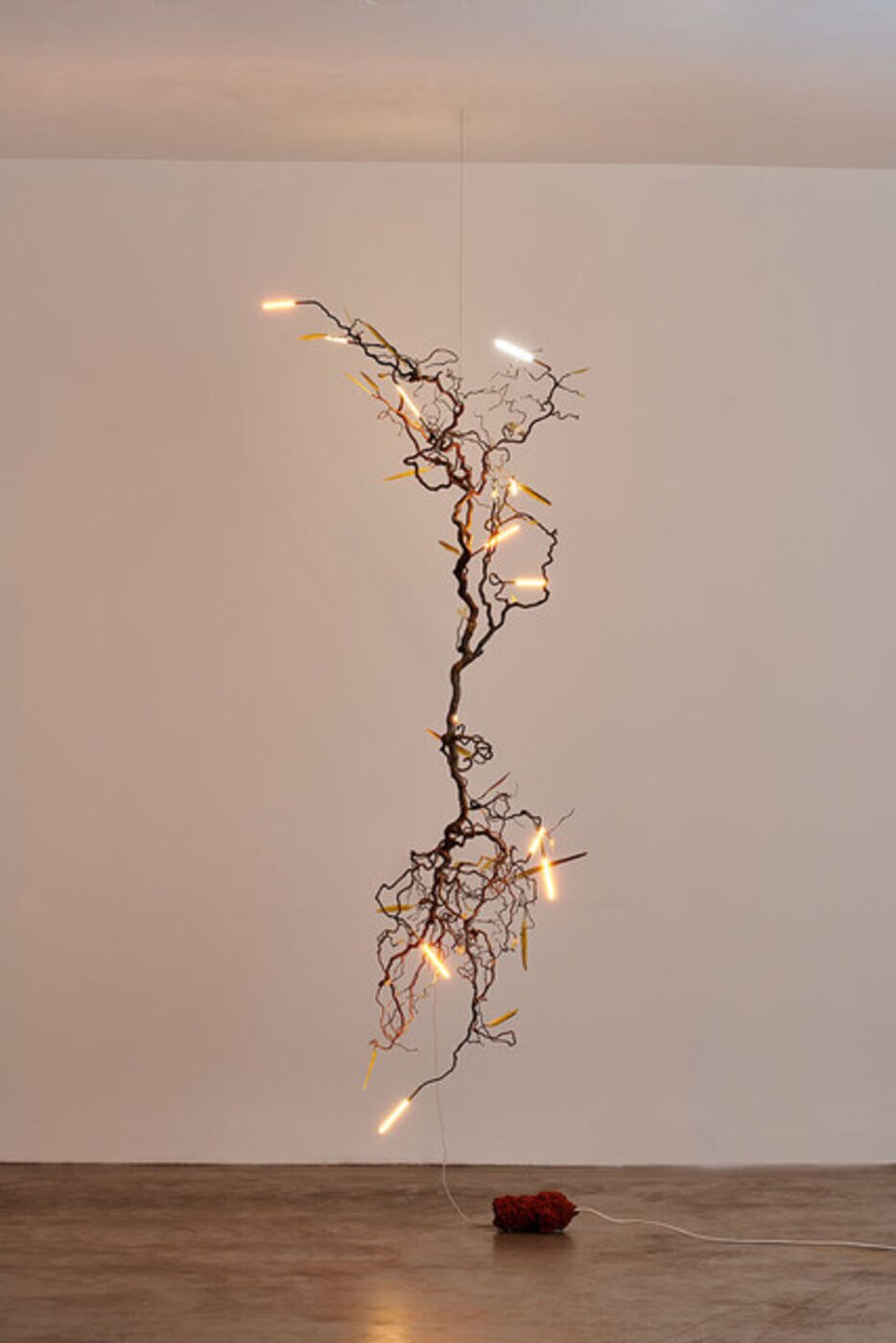 Famiglia pendant with intertwined branches and glowing glass tubes.
