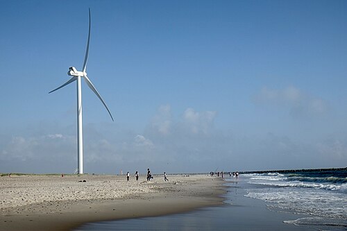 A beach-side wind turbine at Hvide Sande, Denmark, 25 August 2015. One turbine is visible; the image predates the reported 2018 acquisition.